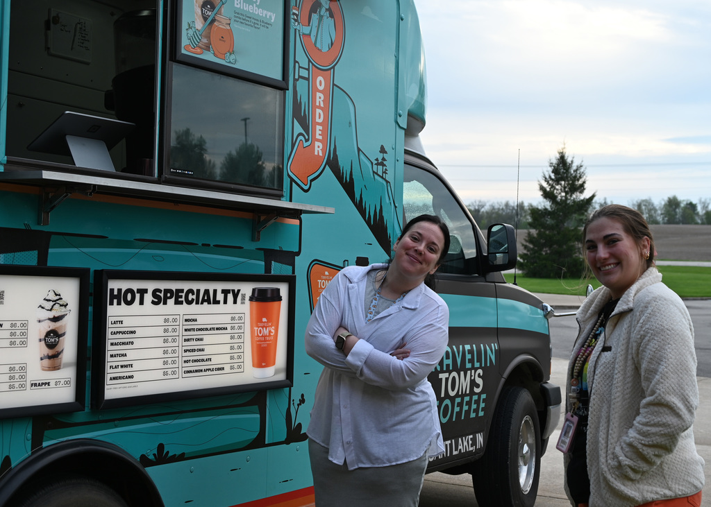 two women in front of coffee truck smiling