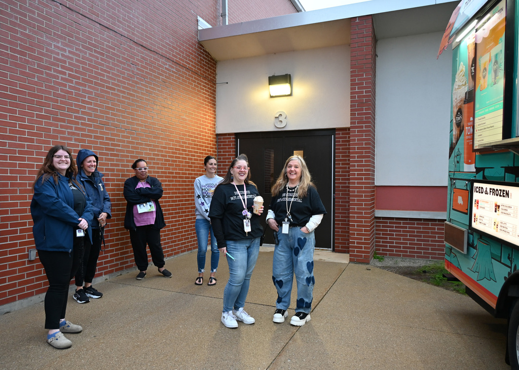 six women standing in fromt of coffee truck smiling