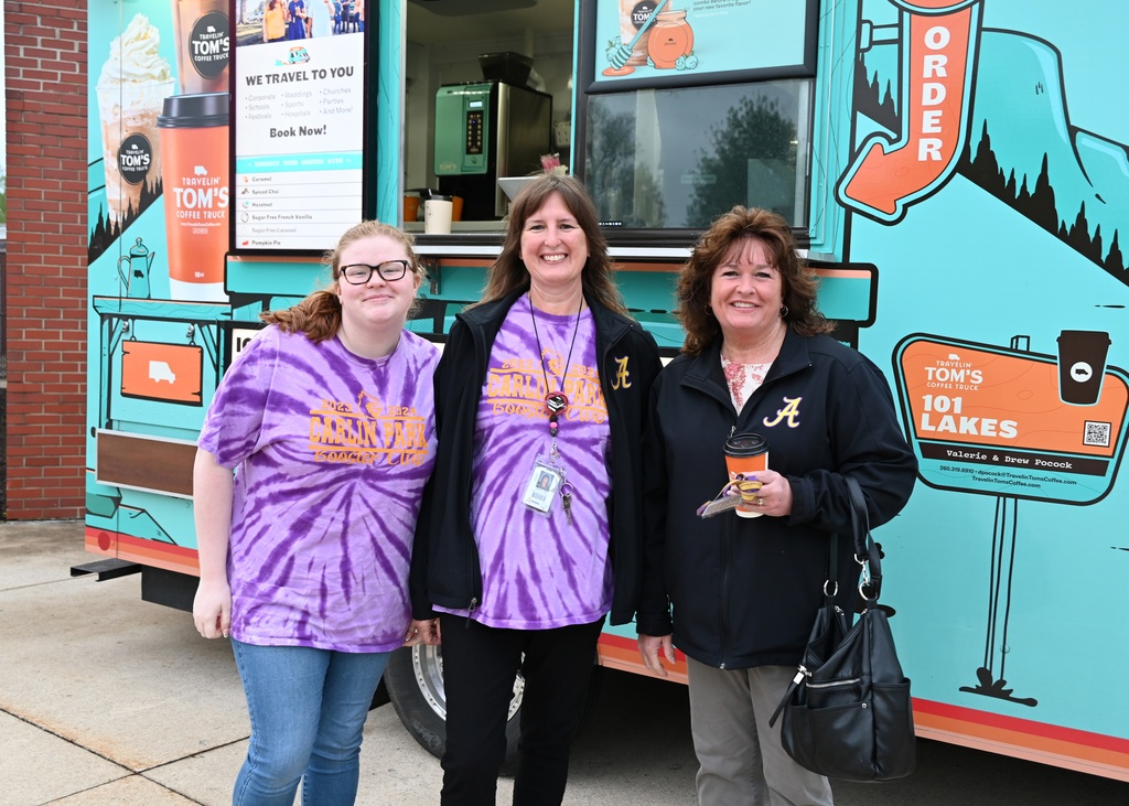three woment standing in front of coffee truck smilling