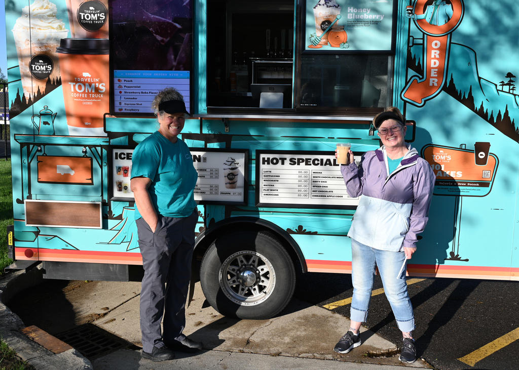 two women in front of coffee truck smiling