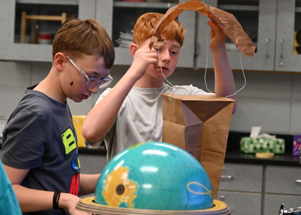 Two middle schooler working on a project