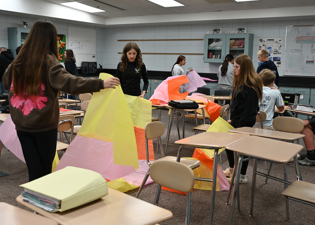 Class room of student working with long sheets of colored paper