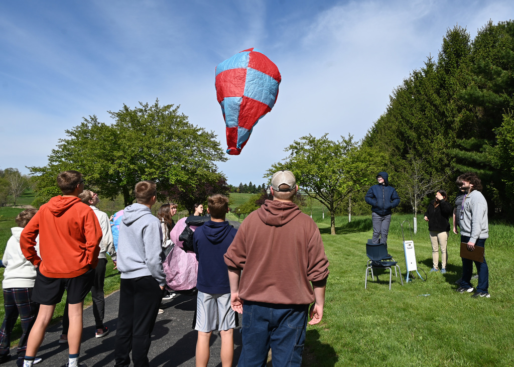 a class of students watching an air balloon
