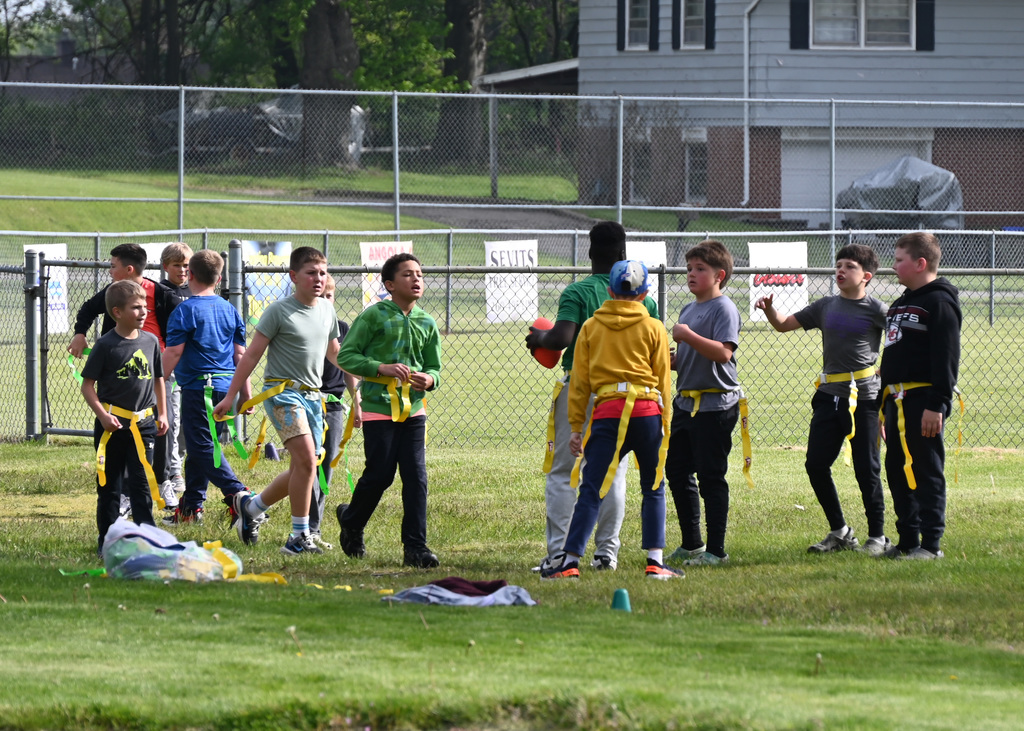 a group of 4th grade students playing tackle football