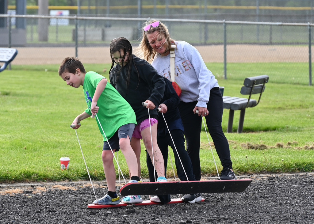 two fourth grade students and a teacher on balance walking planks