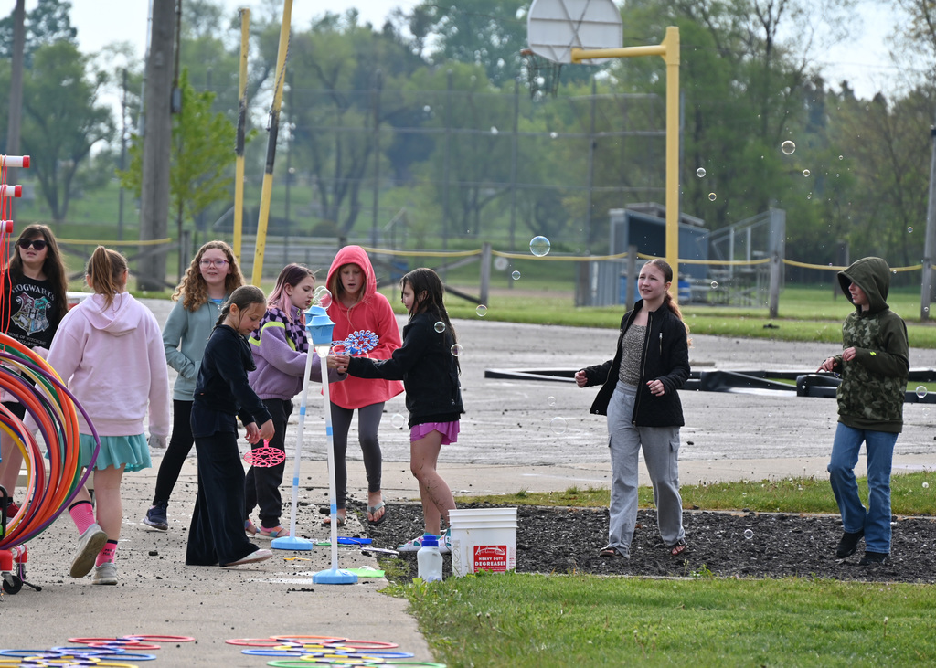 4th grade students outside plaing with bubbles