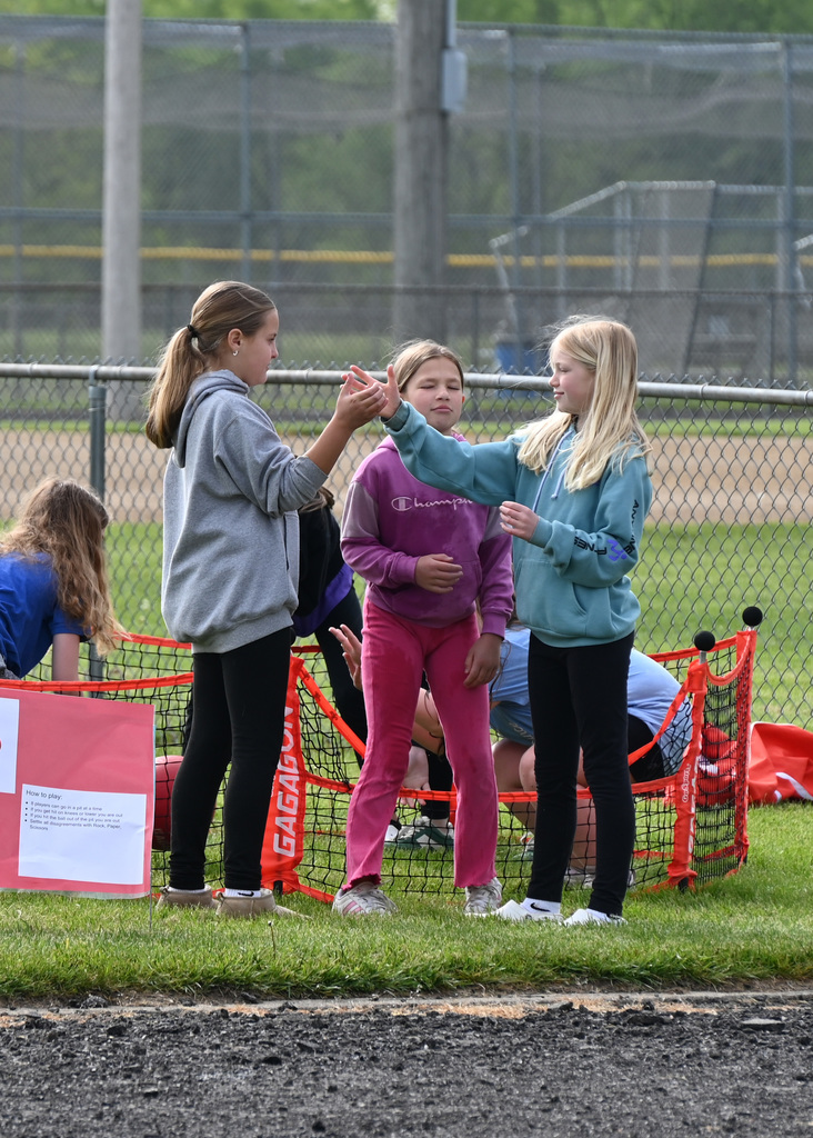 three girls playing hand games
