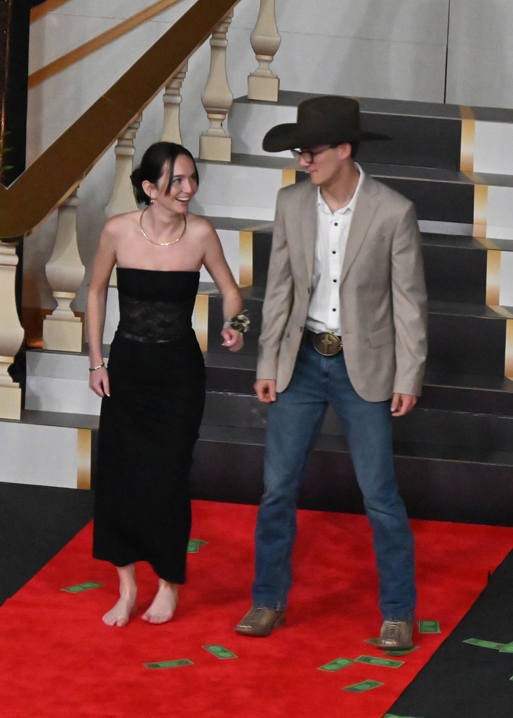 girl in black dress boy in suit dancing