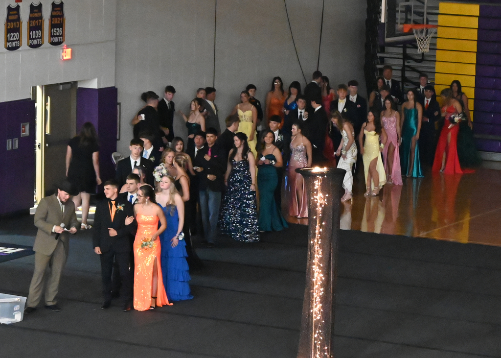 couples in prom attire in a line