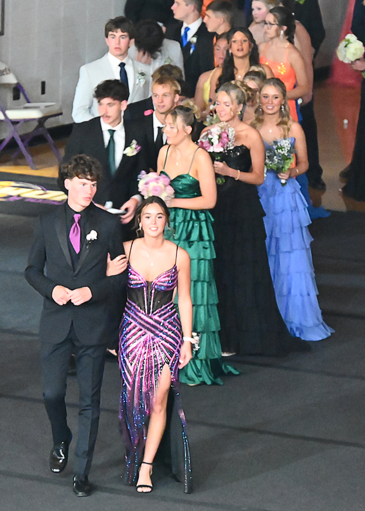couples in prom attire in a line