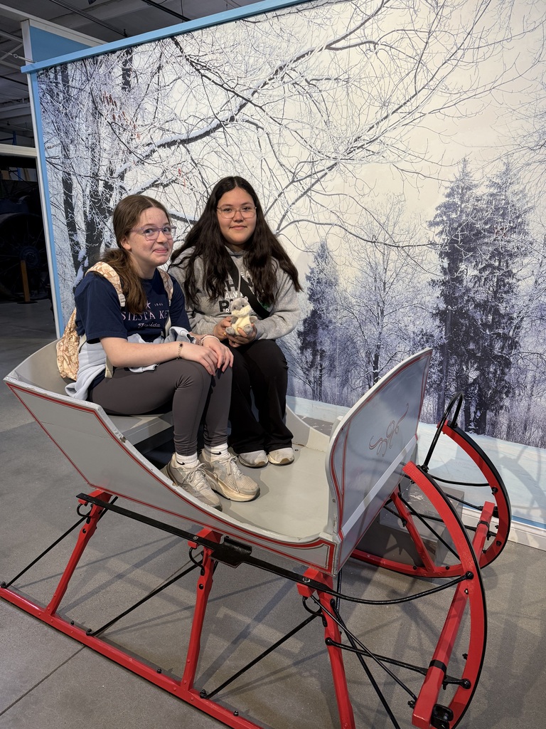 .tow girls in an old fashioned sleigh
