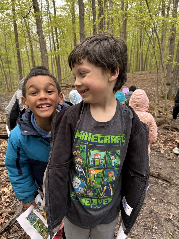 Two boys one looking at the other both smiling