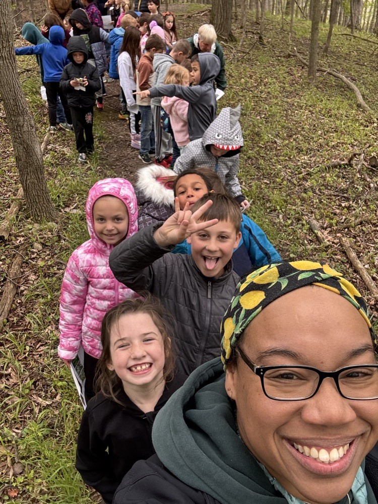 a line of kids ones in front smiling at the camera