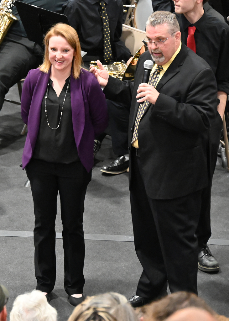 man with microphone standing with woman smiling