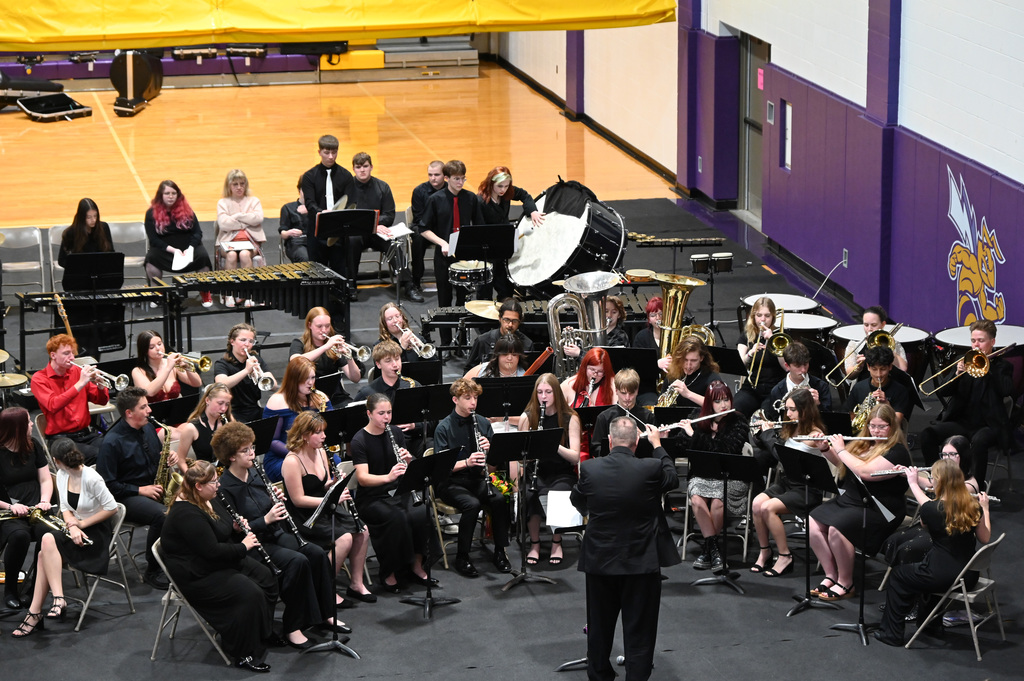 High School band playing being lead by director