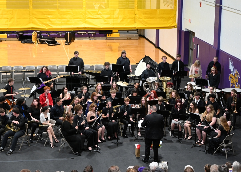 High School band playing being lead by director