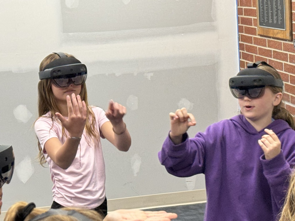 two kids using vr headsets