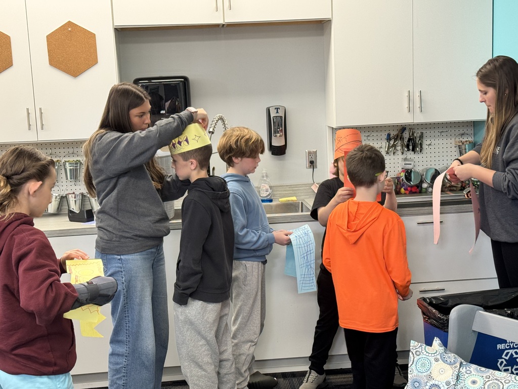 student getting paper crowns put on