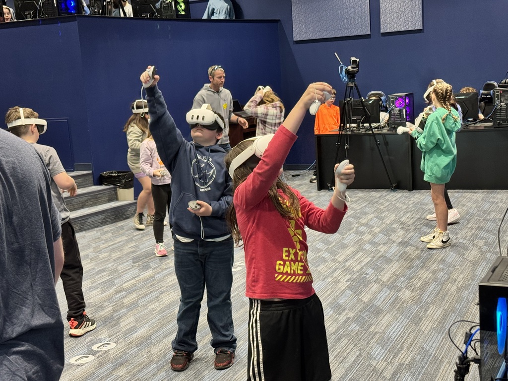 class of kids playing with vr headsets