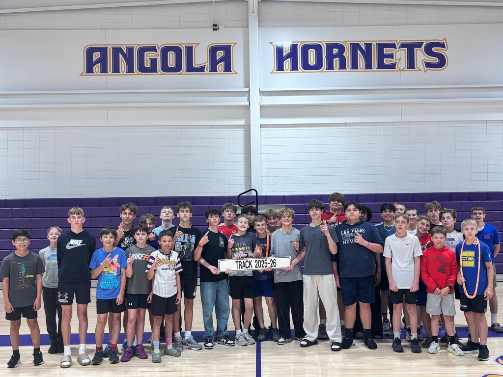 a middle school Boys track team 25 -26 posing together for a picture