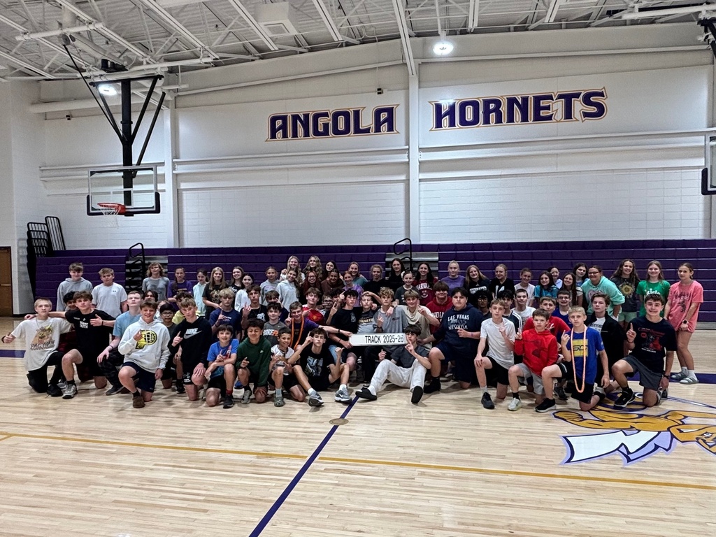 a middle school Boys track team 25 -26 posing together for a picture
