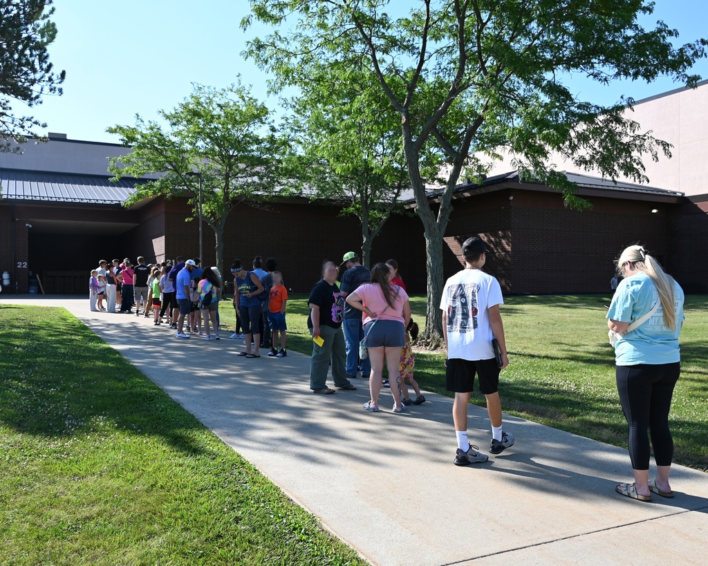 people in line in front of a school