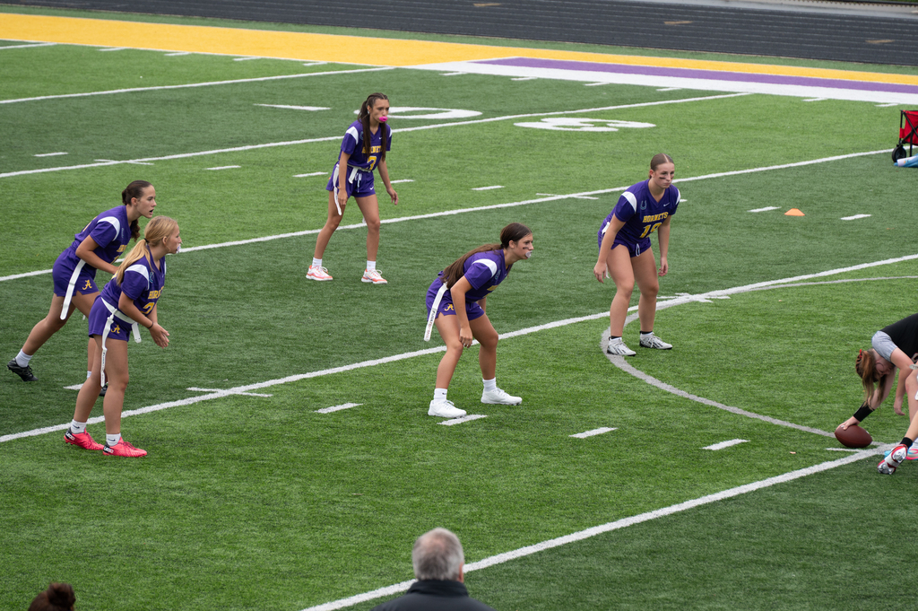 girls on football field in formation for play