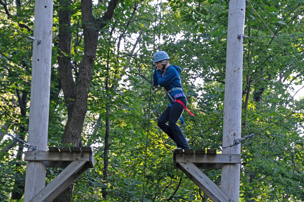 girl crossing from one pole platform to another