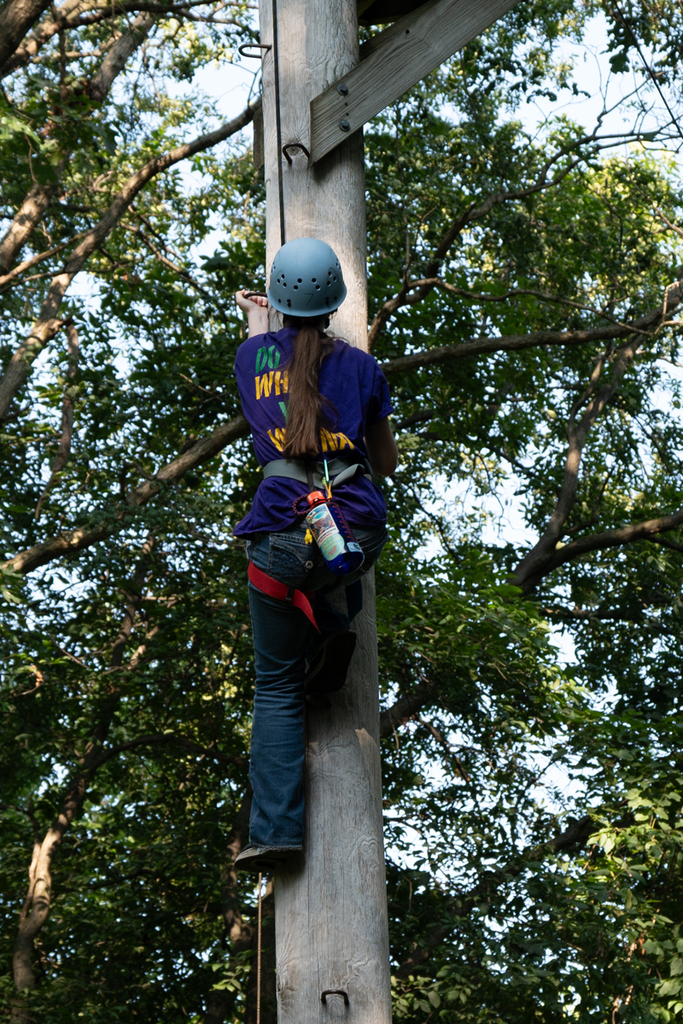girl climbing a pole