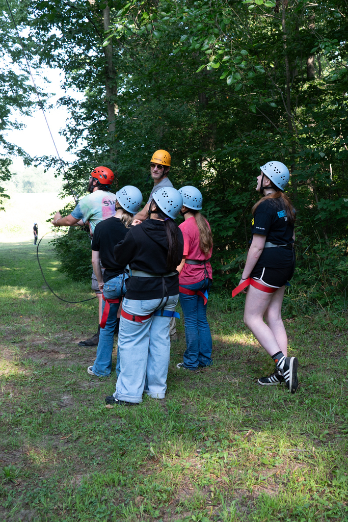 group in hard hats looking up