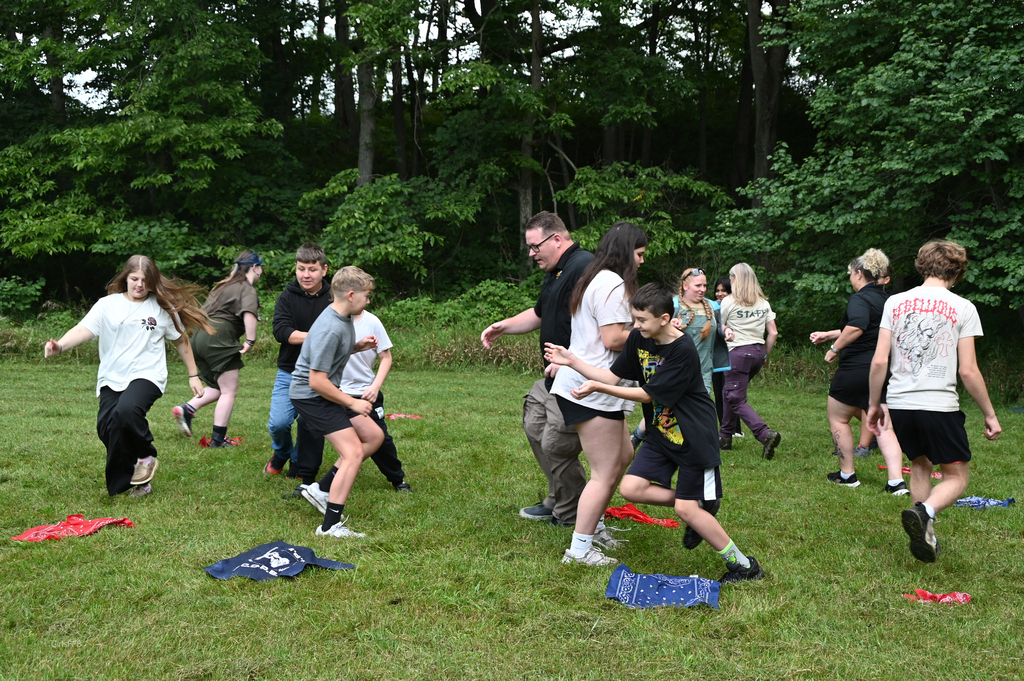 group of people playing tag in fiele