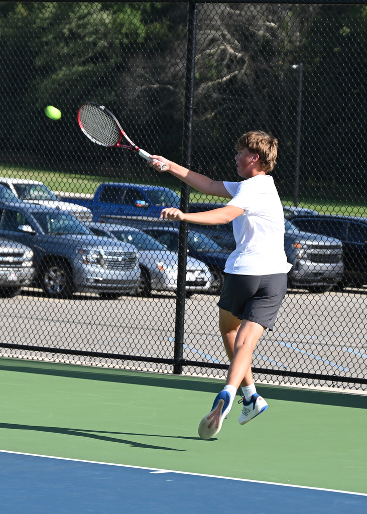 tennis player swinging racket