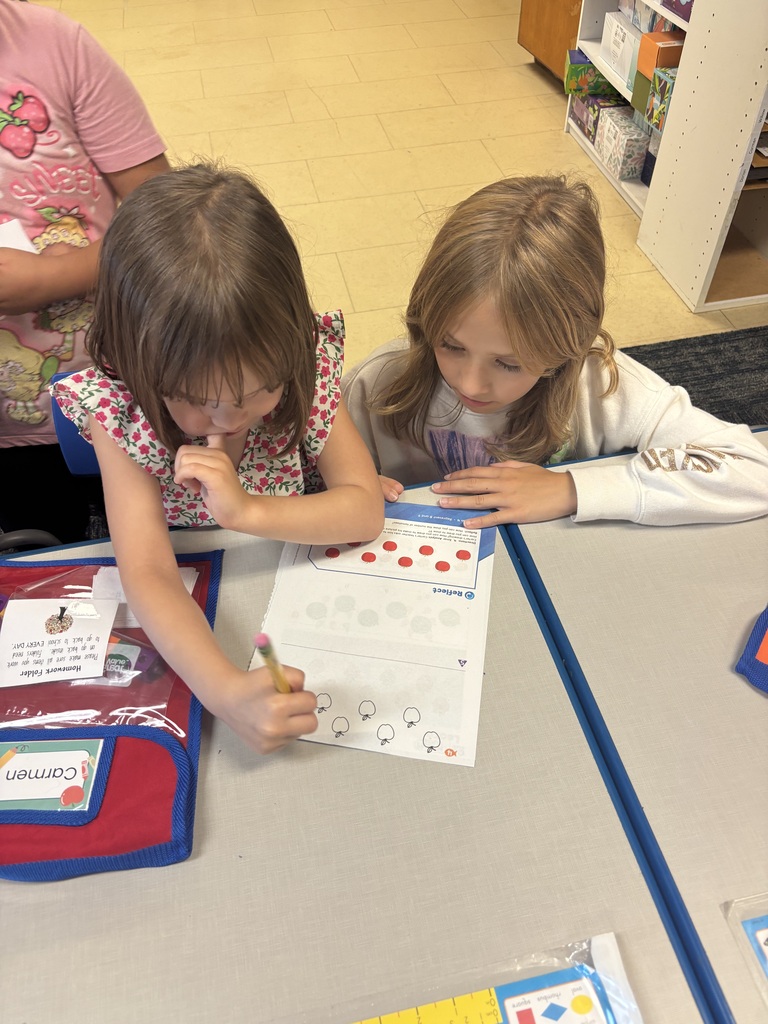 two students working on a paper at table