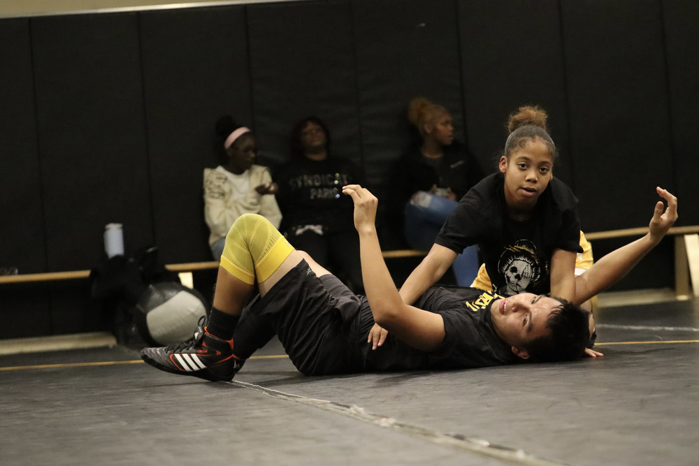 Junior Ryanna Benson demonstrates a wrestling takedown with the help of Coach Adolfo Cruz Gallardo