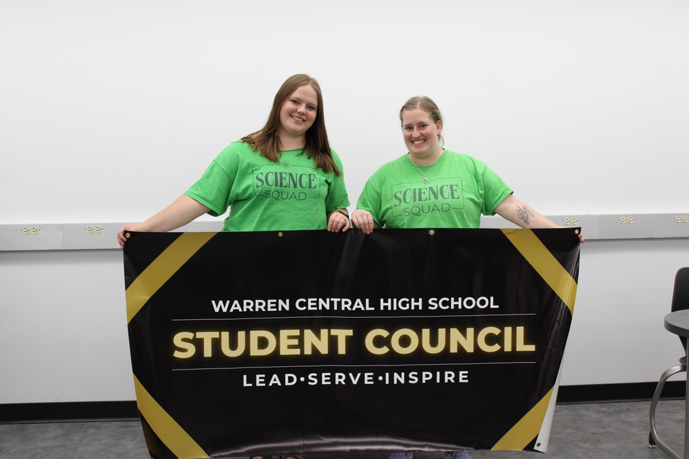 Student Council advisors hold the club banner