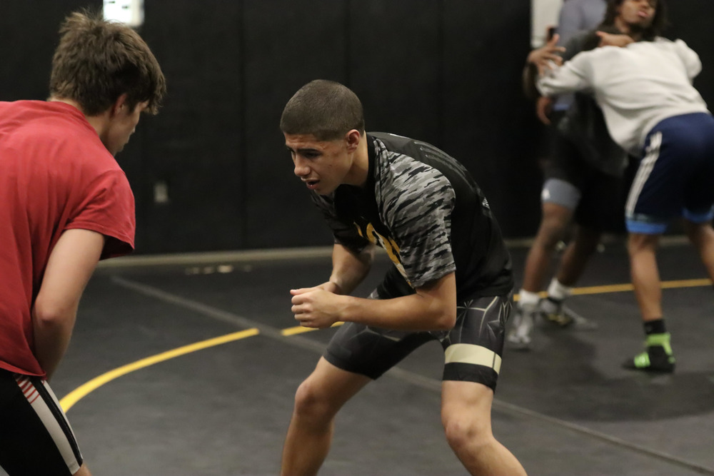 Sophomore Travis Gamble wrestles against his teammate