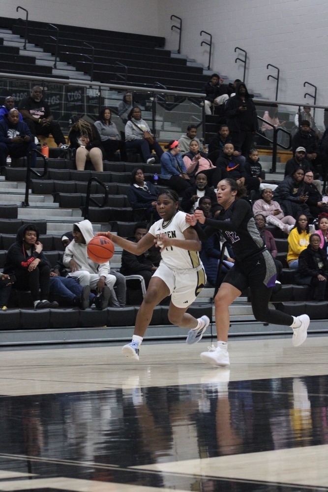 Basketball player dribbling down the court