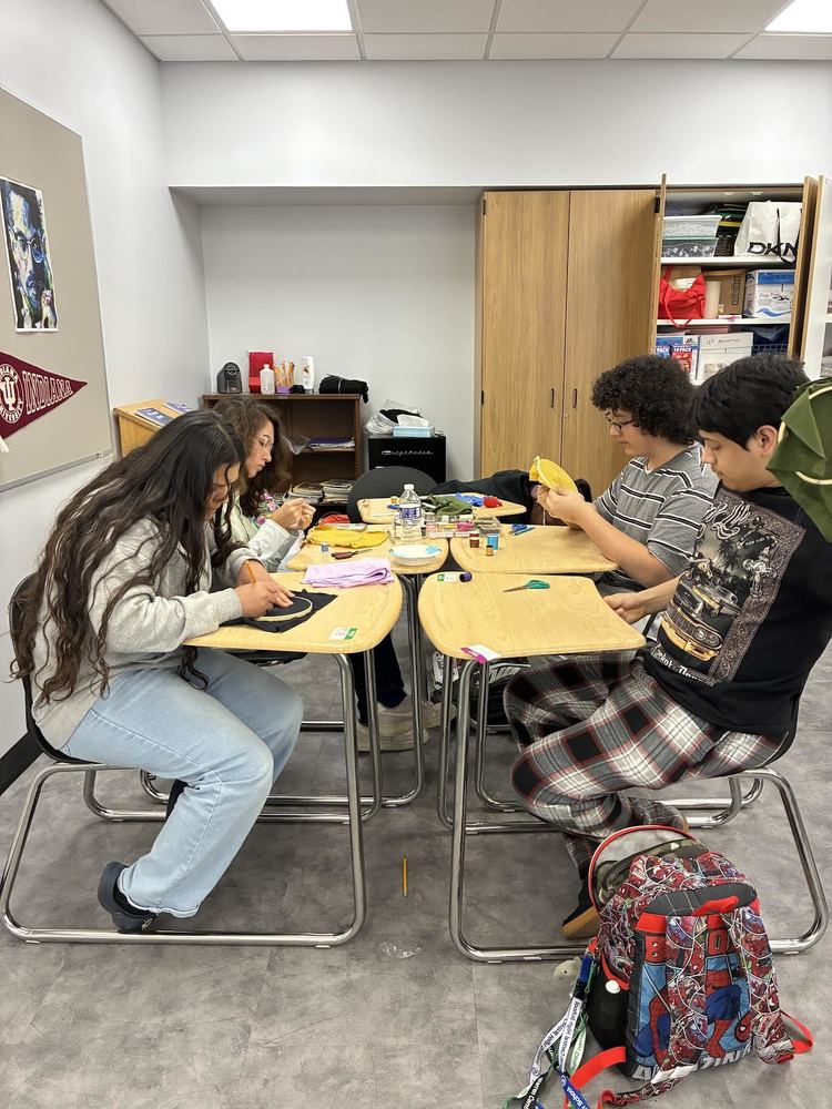 Students learning how to sew