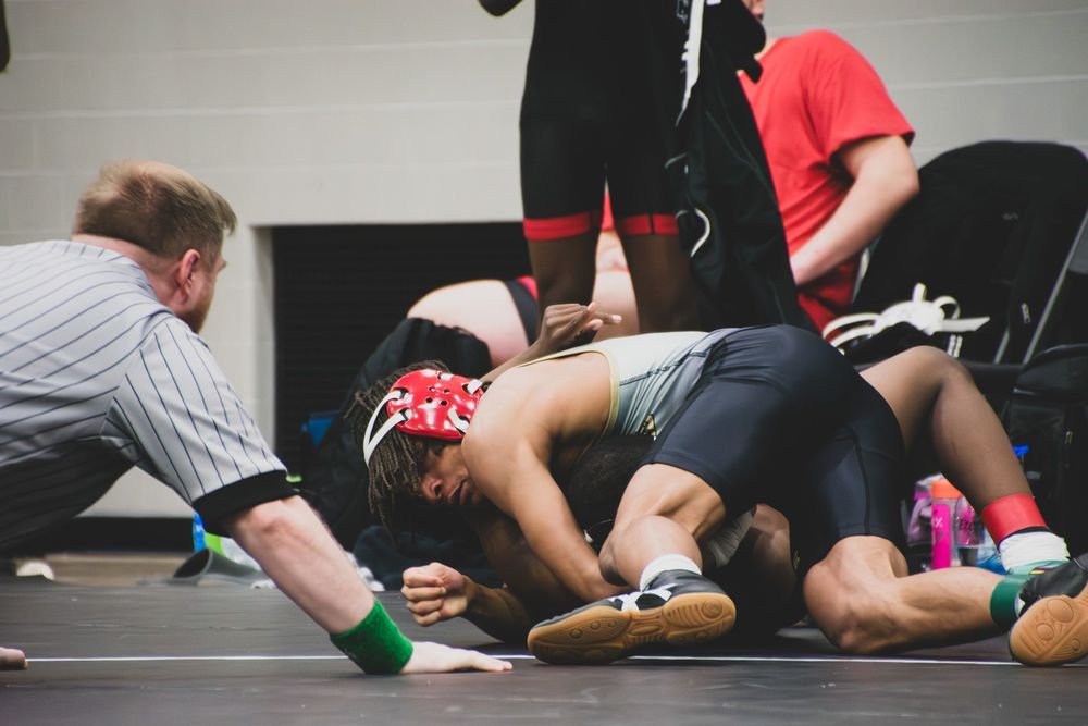 Dylan Wills attempts a pin on his wrestling opponent