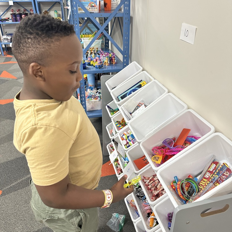 student picking the toy they want to buy