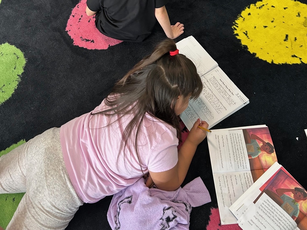 Students answering comprehension questions using complete sentences.