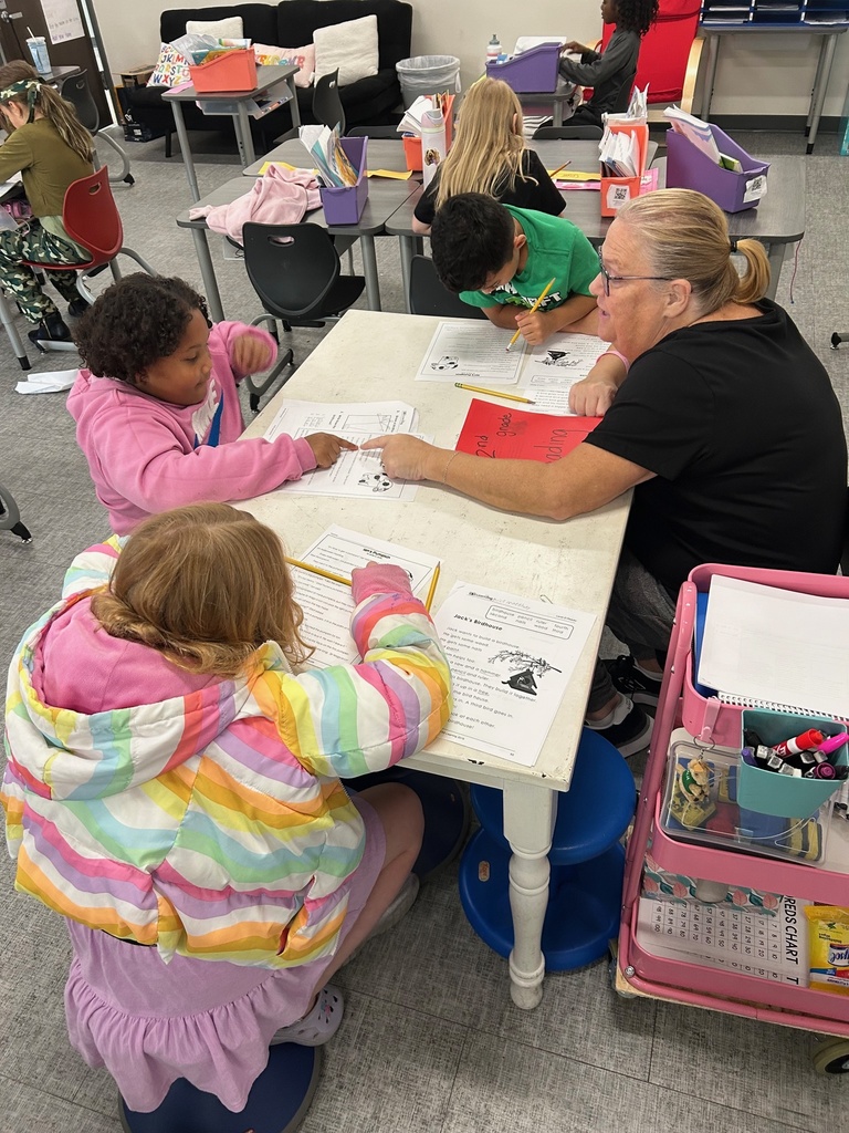 Students going back into the text to find the answers to the comprehension questions.