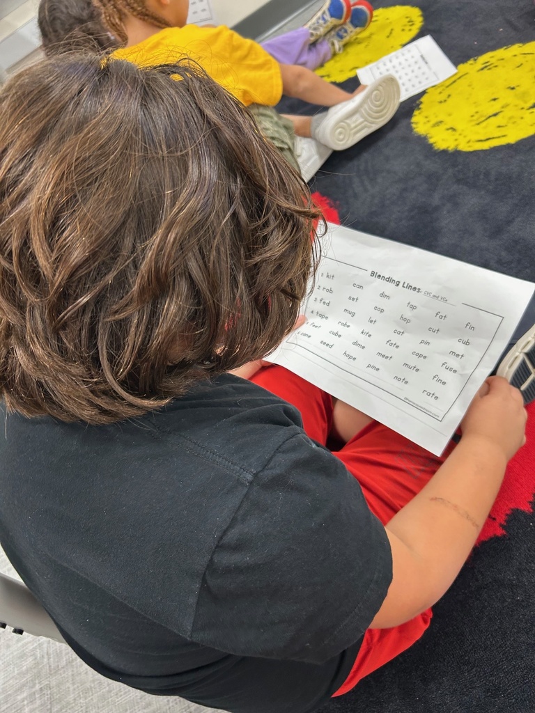 Students reading CVC and VCe words with a partner.