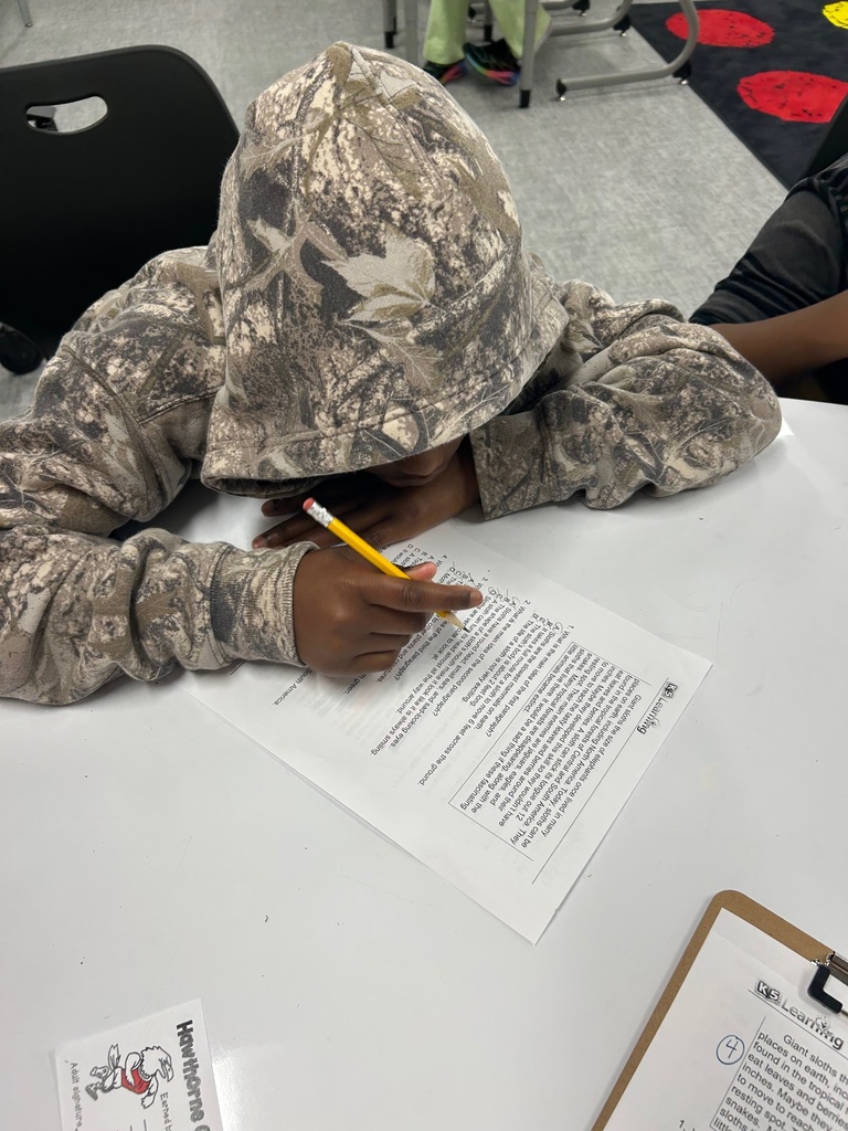 Students determining the main idea and highlighting text evidence.