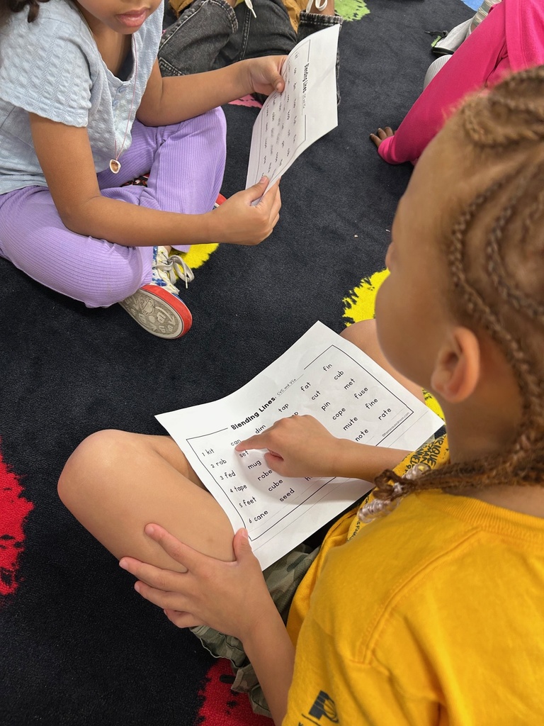 Students reading CVC and VCe words with a partner.