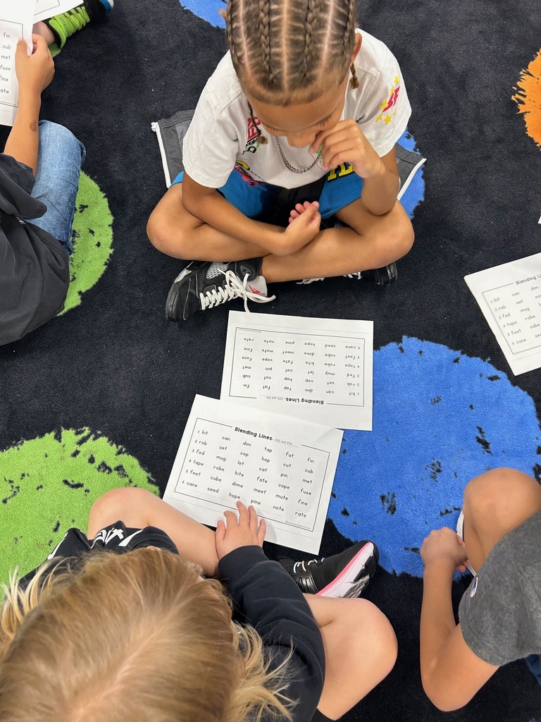 Students reading CVC and VCe words with a partner.