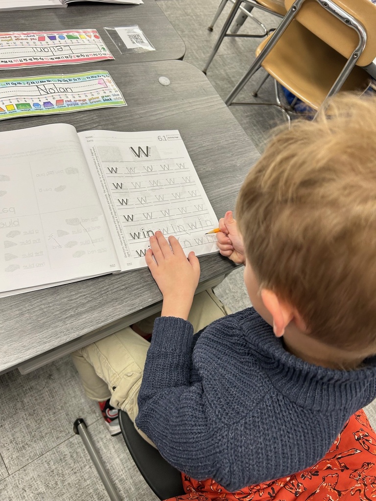 Kindergarten student practicing correct letter formation.