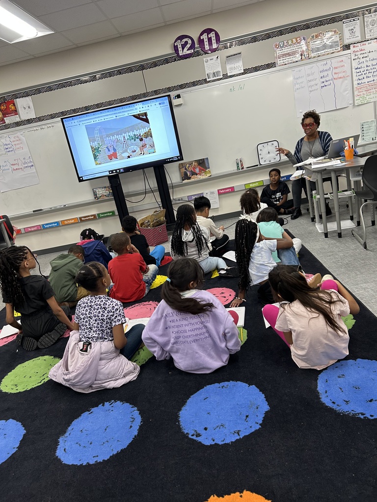 Students engaging in a read aloud by listening and answering questions.