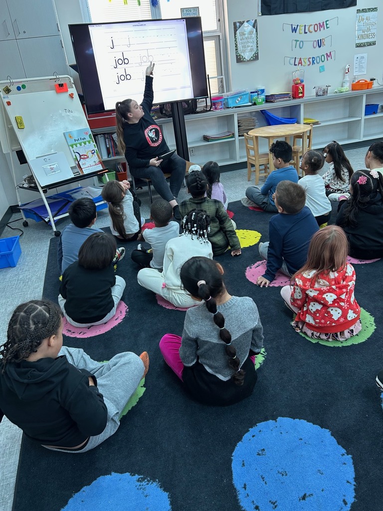 Kindergarten students practicing writing the /j/ sound.