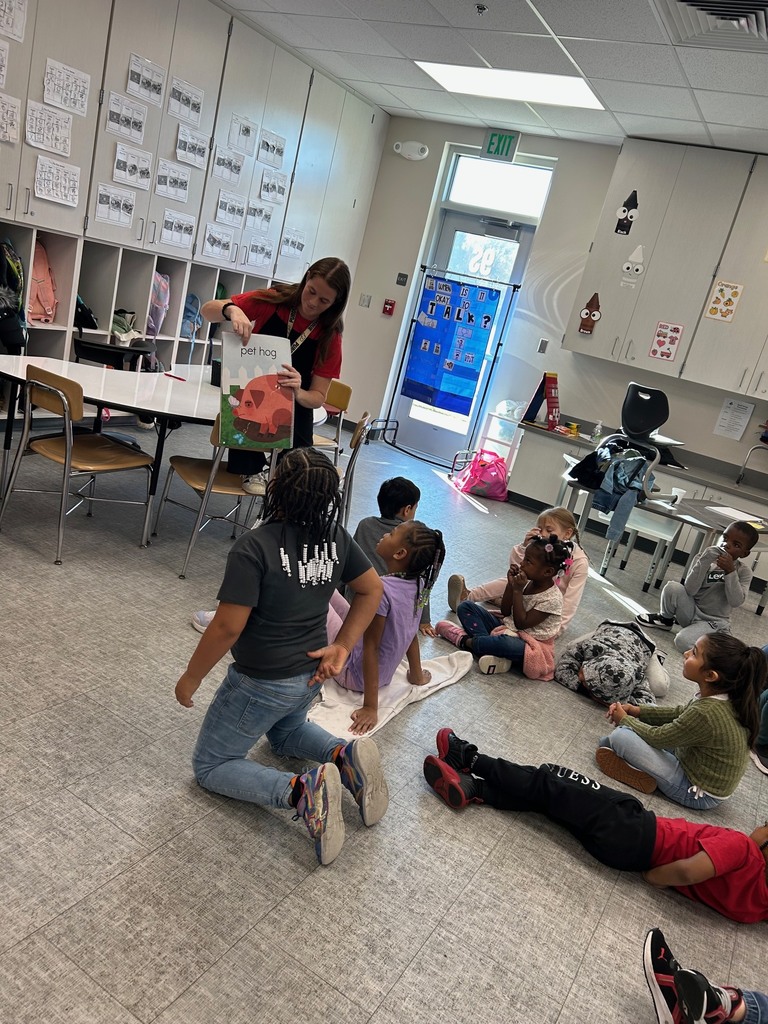 Kindergarten students work in a small group to decod CVC words.